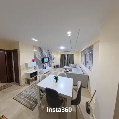 a living room with a table and a couch at New chalet with sea view and private beach access 82m in Hurghada