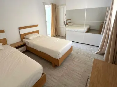 a hotel room with two beds and a mirror at Aqua Palms 2 bedroom apartment - Hurghada Egypt in Hurghada