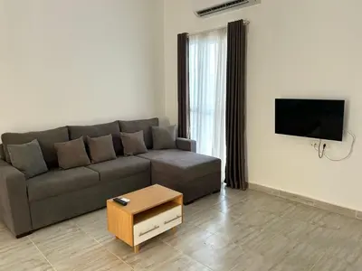 a living room with a couch and a flat screen tv at Aqua Palms 2 bedroom apartment - Hurghada Egypt in Hurghada