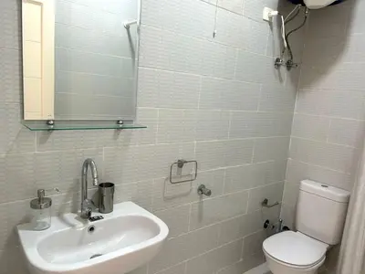 a bathroom with a sink and a toilet and a mirror at Aqua Palms 2 bedroom apartment - Hurghada Egypt in Hurghada