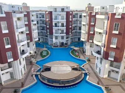 an aerial view of an apartment complex with blue water at Aqua Palms 2 bedroom apartment - Hurghada Egypt in Hurghada