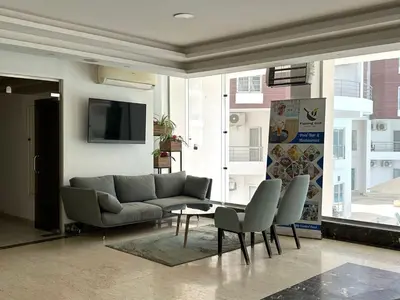 a living room with a couch and a table and chairs at Aqua Palms 2 bedroom apartment - Hurghada Egypt in Hurghada