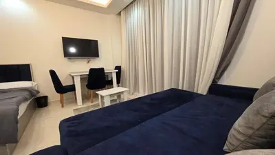 a bedroom with a bed and a desk and a tv at See view Studio-Hurghada Selena Bay Resort in Hurghada