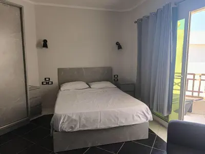 a bedroom with a bed and a window at Royal Beach Resort in Hurghada