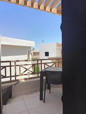 a table and a chair on a balcony at Royal Beach Resort in Hurghada