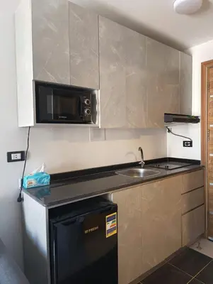 a small kitchen with a sink and a microwave at Royal Beach Resort in Hurghada