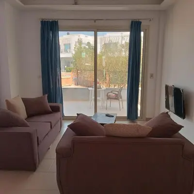 a living room with two couches and a large window at George Villa in Hurghada