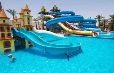 a water slide in a pool at a water park at ميراج باي اكوا بارك in Hurghada