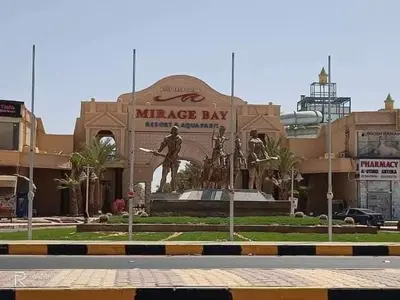 a large building with a statue in front of it at ميراج باي اكوا بارك in Hurghada