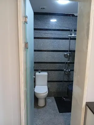 a bathroom with a toilet and a shower at ميراج باي اكوا بارك in Hurghada