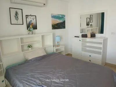 a white bedroom with a bed and a dresser at Holiday Villa in Hurhgada Egypt in Hurghada