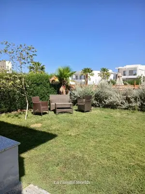 a yard with two chairs and a lawn sidx sidx sidx sidx sidx at Holiday Villa in Hurhgada Egypt in Hurghada
