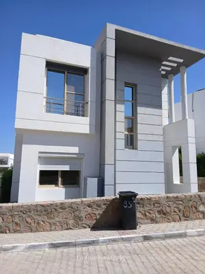 a white house with a trash can in front of it at Holiday Villa in Hurhgada Egypt in Hurghada