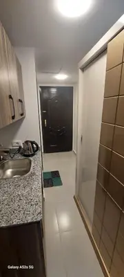 a kitchen with a sink and a door to a hallway at كمبوند فلورنزا خمسين عرابيا in Hurghada