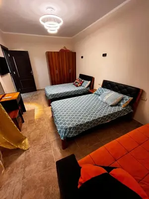 a room with two beds and a couch at Florenza Khamsin GH in Hurghada