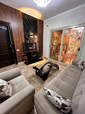 a living room with a couch and a glass table at Florenza Khamsin GH in Hurghada
