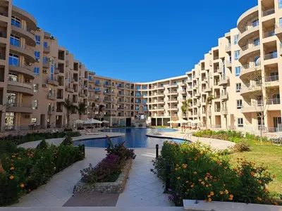 a large apartment complex with a swimming pool and a resort at Florenza Khamsin GH in Hurghada