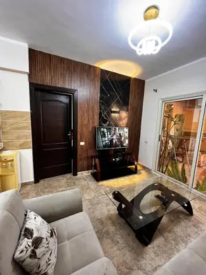 a living room with a couch and a glass table at Florenza Khamsin GH in Hurghada