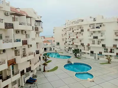 an overhead view of two swimming pools in a building at شاليه فندقي فاخر كومباوند طيبة فيو حي الوزراء in Hurghada