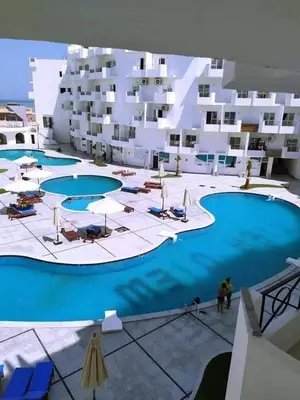 a large swimming pool in front of a building at شاليه فندقي فاخر كومباوند طيبة فيو حي الوزراء in Hurghada