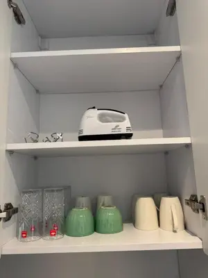 a shelf with a toaster and other kitchen items at Aldau Heights Modern Serenity Studio in Hurghada