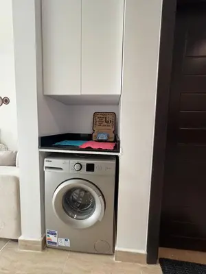 a washing machine with a box on top of it at Aldau Heights Modern Serenity Studio in Hurghada