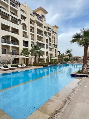 a large swimming pool in front of a building at Aldau Heights Modern Serenity Studio in Hurghada