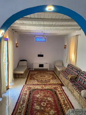 a living room with two couches and a rug at Home of Natural in Luxor