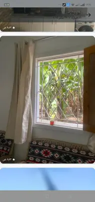 a window in a room with a rug in front of it at Home of Natural in Luxor
