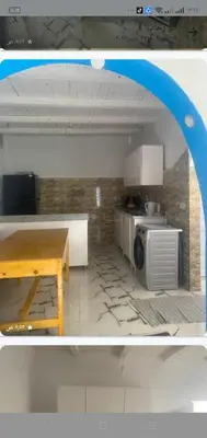 a kitchen with a table and a microwave at Home of Natural in Luxor