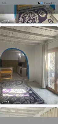 a bedroom with a bed in a room with a window at Home of Natural in Luxor