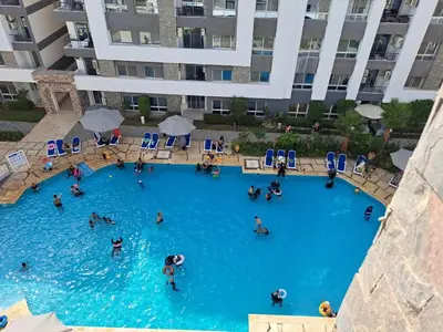 a group of people in a large swimming pool at Amazing Apartment in Fanadir Hotel with Nice View F408 in Hurghada