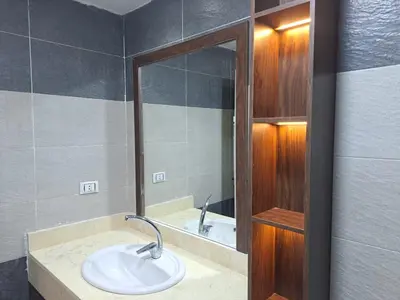 a bathroom with a sink and a mirror at Amazing Apartment in Fanadir Hotel with Nice View F408 in Hurghada