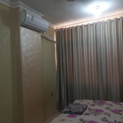 a bedroom with a bed and a shower with a curtain at شقه للايجار اليومي بمدينة الغردقه مميزة جدا in Hurghada