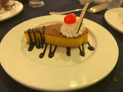 a piece of cake with a cherry on top on a plate at Pause for a while in Hurghada