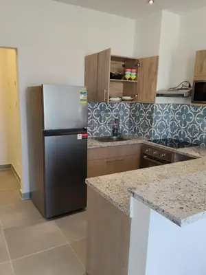 a kitchen with a refrigerator and a counter top at One B2b Apartment w balcony with Jacuzzi at Makadi Heights in Hurghada