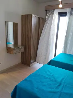 a bedroom with a blue bed and a window at One B2b Apartment w balcony with Jacuzzi at Makadi Heights in Hurghada