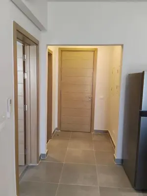 an empty hallway with a door and a tile floor at One B2b Apartment w balcony with Jacuzzi at Makadi Heights in Hurghada