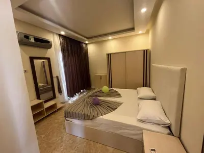 a bedroom with a bed with a tennis ball on it at شاليه في قرية ميراج in Hurghada