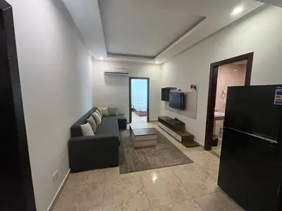 a living room with a couch and a tv at شاليه في قرية ميراج in Hurghada