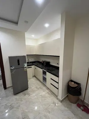 a kitchen with a refrigerator in a room at شاليه في قرية ميراج in Hurghada