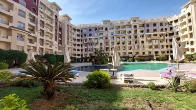 a large apartment building with a large swimming pool at Florenza Khamsim 307 in Hurghada