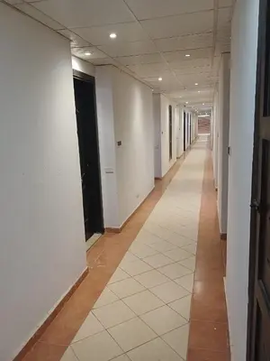 an empty hallway of an office building with white walls at Cozy studio in Florenza Khamsim - I409 in Hurghada