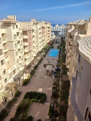 an aerial view of a courtyard between two buildings at Cozy studio in Florenza Khamsim - I409 in Hurghada