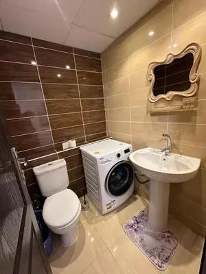 a bathroom with a washing machine and a sink at Cozy studio in Florenza Khamsim - I409 in Hurghada