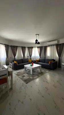 a living room with a couch and a table at Stylish 2BD 2Bath Regency towers in Hurghada