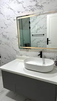 a white bathroom with a sink and a mirror at Stylish 2BD 2Bath Regency towers in Hurghada