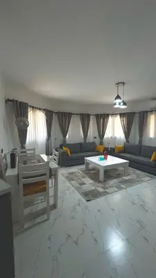 a living room with couches and a table at Stylish 2BD 2Bath Regency towers in Hurghada