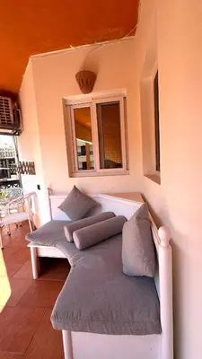 a room with a bench with pillows and a window at Stylish 2BD 2Bath Regency towers in Hurghada