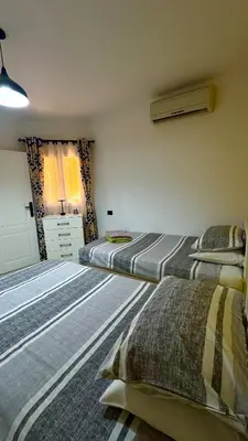a bedroom with three beds in a room at Stylish 2BD 2Bath Regency towers in Hurghada
